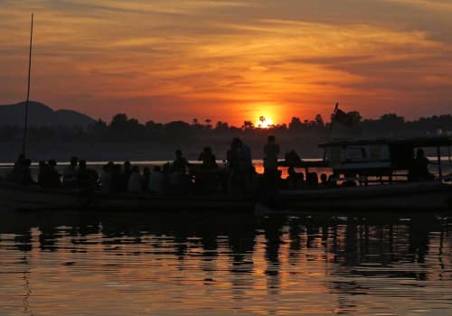 People on a boat taking photos pf the sunset