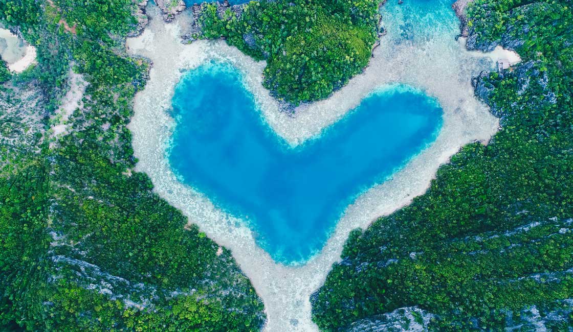 Coral reef and islands shaping water into a heart
