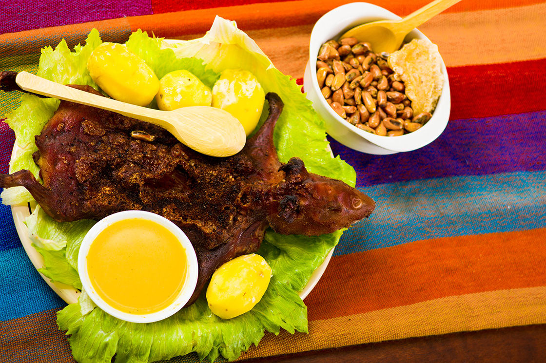 Traditional Ecuadorian Dish Grilled Guinea Pig Spread Out Onto Green
