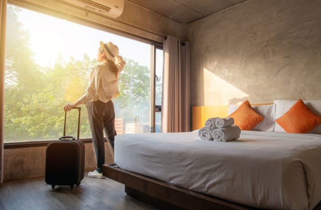 Solo traveler female in front of window at hotel