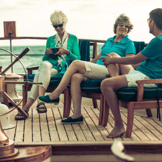 People laughing sitting on a deck