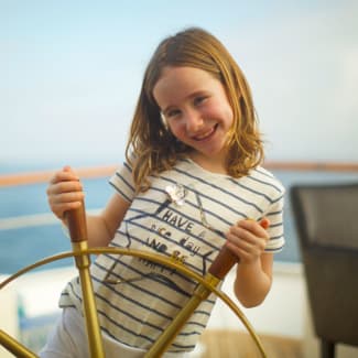 Smiling girl with a stearing wheel