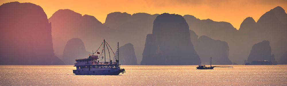 Boat in Halong bay at sunset