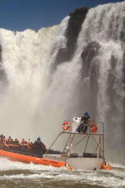 People In Boat To See The Waterfalls Up Close
