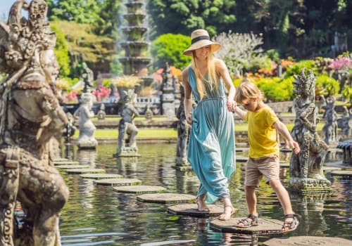 mommy and son walking throught a water garden full of stone statues