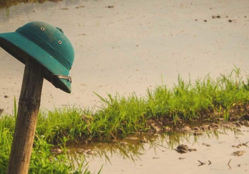 Vietnamese military helmet on a bamboo pole